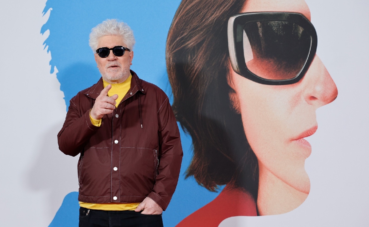 El cineasta Pedro Almodóvar frente a un póster de su película ‘Amarga Navidad’. (EFE)