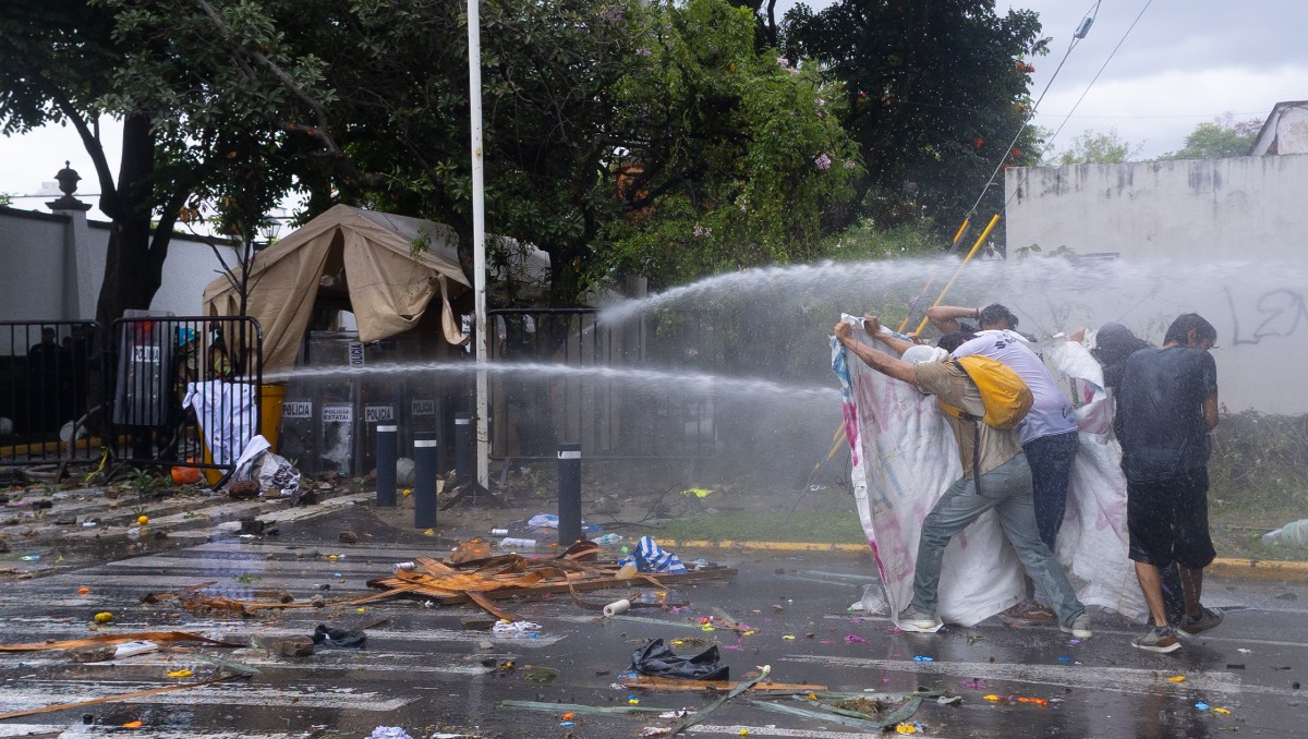 En la marcha del agua bomberos lanzaron chorros de agua contra los manifestantes en Casa Jalisco(Farid Santos)